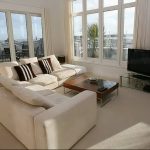 Modern furnished living room with plasma TV