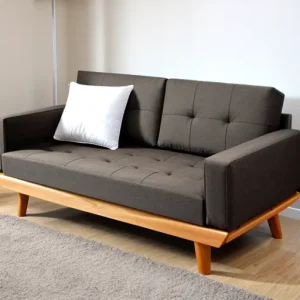 Современная гостиная, серый диван, деревянные ножки, белая подушка, серый ковер, минималистичный дизайн.