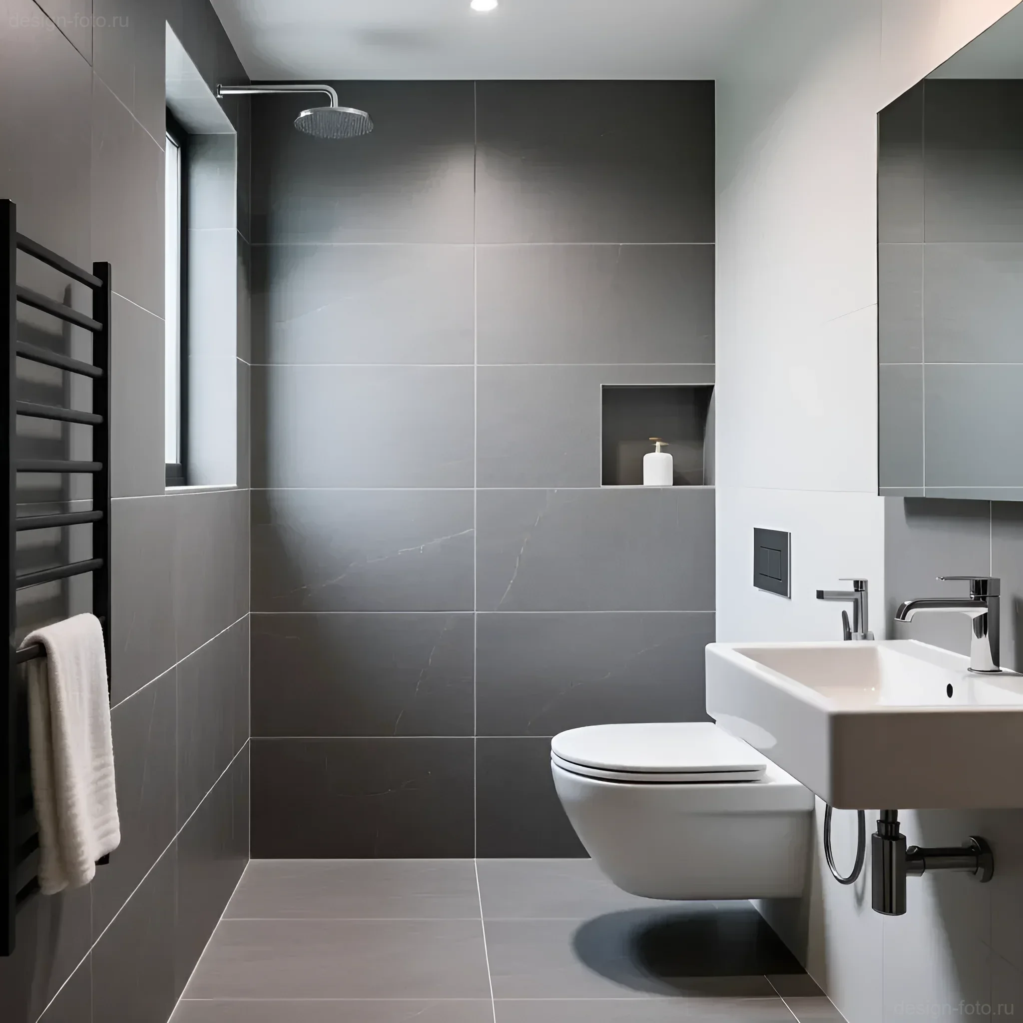 Современная ванная комната с крупноформатной графитовой плиткой и белой сантехникой, акцент на визуальном увеличении пространства.